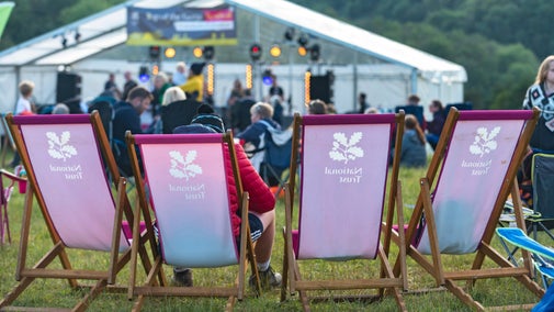 Visitors sat in deckchairs at Top of the Gorge Festival 2019 at Cheddar Gorge, Somerset